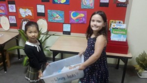 Two children take the Library books to the Library. 